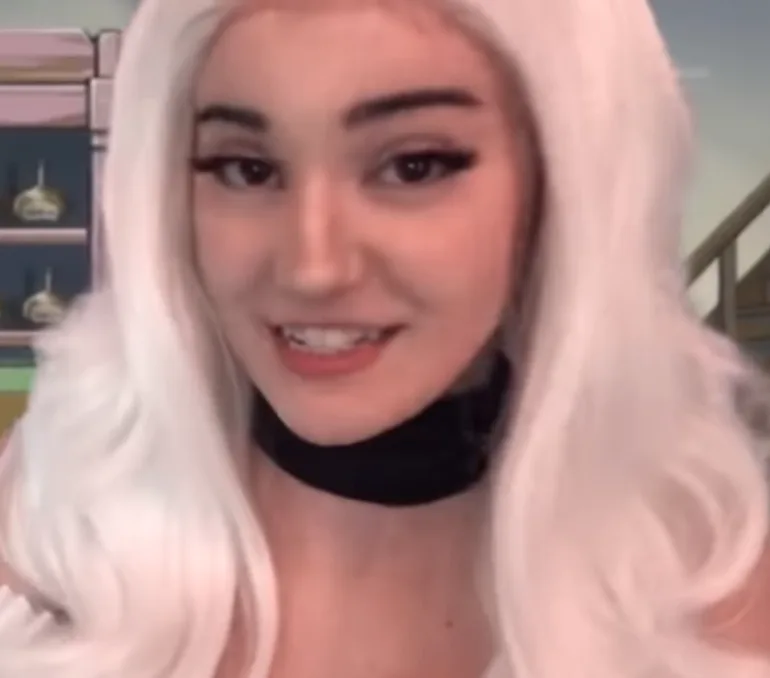 jinx asmr with blonde hair and a black collar