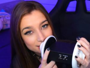 "akuma asmr" with dark brown hair speaking into a microphone.