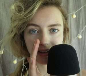 "Gloria Asmr" talking into a microphone.