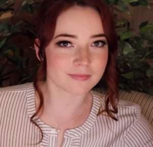 "Goodnight Moon Asmr" with red hair and a top.