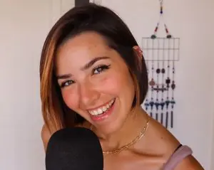 "ASMR Glow" smiling in front of a microphone