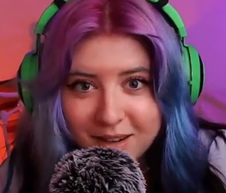 "Doris ASMR" with green headphones and purple hair.