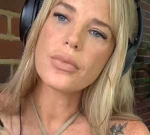 "Lucy ASMR" with blonde hair and tilted head.