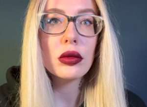 "Karuna Satori ASMR" with blonde hair and red lips.