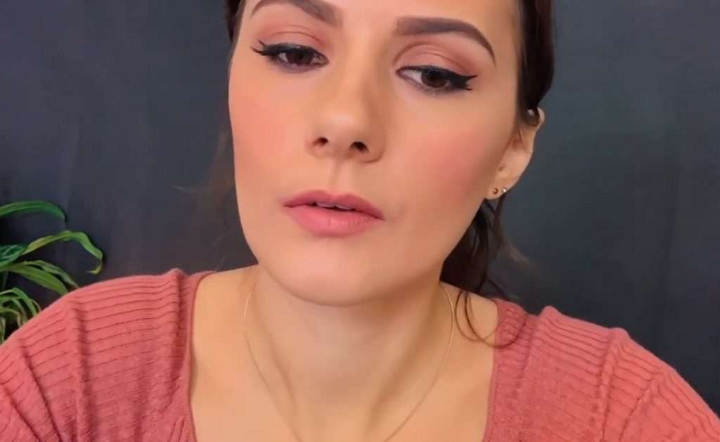 Lotz ASMR in a pink shirt during a close-up ASMR video