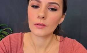 Lotz ASMR in a pink shirt during a close-up ASMR video