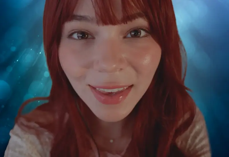 MaimyNyan with red hair smiling.