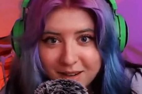 Doris ASMR "Doris ASMR" with green headphones and purple hair.