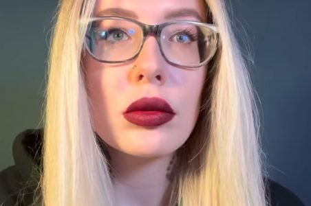 "Karuna Satori ASMR" with blonde hair and red lips.
