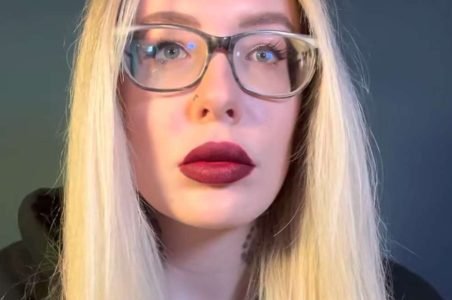 "Karuna Satori ASMR" with blonde hair and red lips.