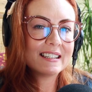 Whispers Red ASMR "whispers red asmr" wearing glasses with red hair and headphones.