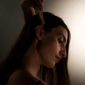 beautiful lady using a comb to brush her hair