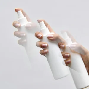 3 white water spray bottles with mist about to be sprayed out